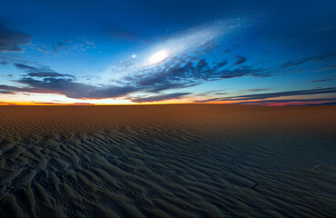 Poster - Amazing view of the blue desert under the night starry sky with Andromeda galaxy 
