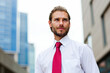 © Minerva Studio - Confident businessman looking up in the financial district
