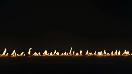 Poster - Small flames dancing and creating a fiery line against a dark backdrop, offering a striking and visually captivating contrast that highlights the beauty of light and shadow