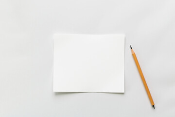 White paper with pencil in minimalist style with copy space for text or notes against a clean background