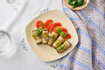 Wall Mural - Appetizing Eggplant Rolls with Cheese on Rustic Plate Bright Natural Light and Earthy Textures