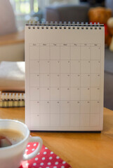Wall Mural - desktop calendar, and cup of coffee placed on student wooden desk. calender for planner to plan dail