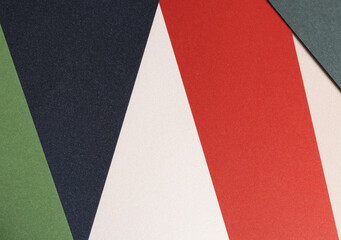 Poster - Modern geometric paper composition with bold contrasting colors, including green, navy blue, red, and off-white, layered with textured surfaces, creating a stylish and artistic minimalist design.
