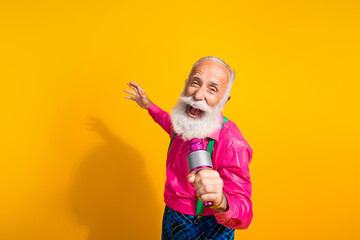 Wall Mural - Photo of nice senior male have fun sing karaoke wear pink shirt plaid pants suspenders fancy outfit isolated on yellow color background