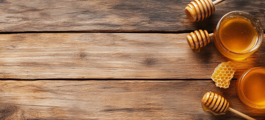 Poster - Organic honey in jars sits on a rustic wooden surface alongside honeycomb and honey dipper sticks. This setting reflects the essence of natural beekeeping and the sweetness of fresh honey.