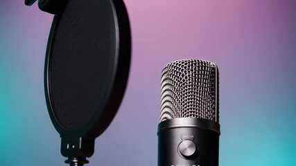Poster - Professional studio microphone standing near pop filter, positioned for podcasting with colorful pink blue gradient background, capturing essential audio recording equipment in smooth slow motion