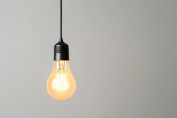 Poster - Lightbulb softly glowing with a delicate filament inside, solid twilight navy background