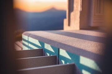 Poster - Sunset casts shadows on a textured stone surface, creating a serene and peaceful outdoor scene.
