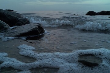 Wall Mural - Coastal Serenity: Waves Crashing on Rocks at Dusk