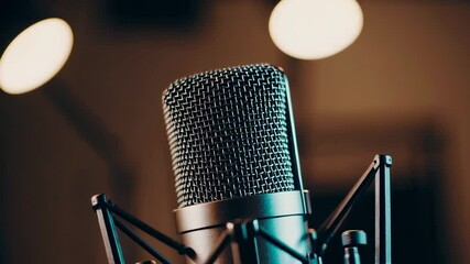 Poster - Professional studio microphone standing near soft glowing lights, capturing immersive audio recording environment with sleek modern aesthetic in atmospheric slow motion