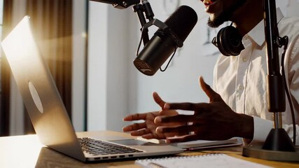 Poster - Content creator wearing professional headphones gesturing dynamically while recording podcast audio with high end microphone and laptop in dramatic slow motion lighting