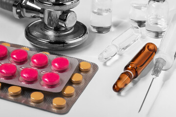 Wall Mural - medical tablets in a blister, medical ampoules with medicines and a medical syringe.