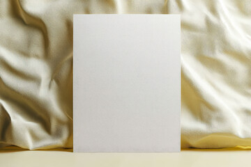 Wall Mural - white piece of paper is on a gold background. the paper is blank and has no writing on it. the gold 