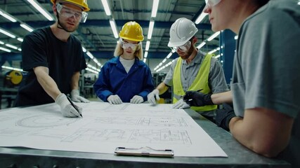 Aufkleber - Industrial engineers and technicians in safety gear are examining and discussing a blueprint on a large table in a modern factory, collaborating on a project in slow motion