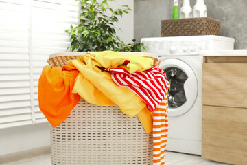 Wall Mural - Wicker basket full of laundry in bathroom