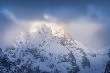 Wall Mural - USA, Wyoming, Grand Teton National Park. Spring snowstorm over Teton Range at sunrise.