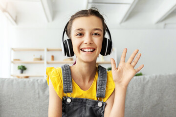 Poster - Web-based Education, Remote Communication Concept. Portrait of smiling girl wearing wireless headphones studying at online school, attending distant course using pc waving hand hi, webcam view