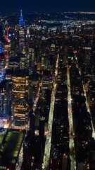 Wall Mural - Sparkling never sleeping New York at night. Vast cityscape of metropolis from drone footage.