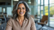 © Alma - Professional Businesswoman Smiling in a Modern Office with a Professional and Friendly Expression