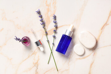 Sticker - Bottles of lavender essential oil, spa stones and flowers on marble background