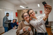 © Miljan Živković - two female colleagues on the break take a self portrait at office