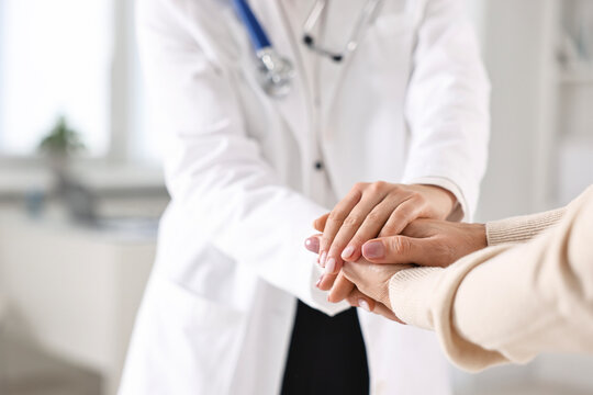 Wall Mural -  - doctor supporting patient during appointment in hospital, closeup of hands