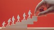 © jamhur - Hand guiding figures ascending career steps, red background
