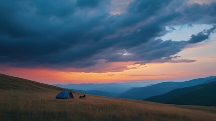 Poster - A serene campsite at dusk, with a tent set against a backdrop of mountains and vibrant sky.