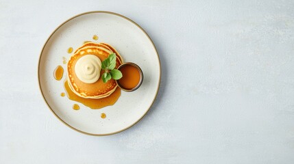 Elegant Plating of Pancakes with Maple Syrup and Mint Garnish