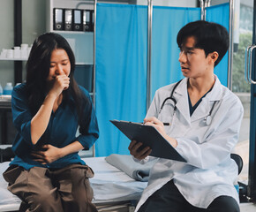 Wall Mural - doctor consulting senior old patient filling form at consultation. Professional physician wearing white coat talking to mature woman signing medical paper at appointment visit in clinic.