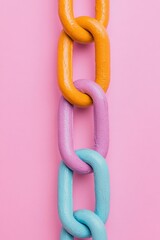 Poster - Colorful Chain Link Art Installation Pastel Painted Connections on Vivid Backdrop - Creative Collaboration and Team Synergy in Modern Office Design