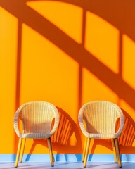 Leinwandbilder - Vibrant Minimalist Seating Woven Rattan Chairs against Orange Accent Wall - Creative Workspace Decor and Contemporary Design for Inspiring Professional Environments
