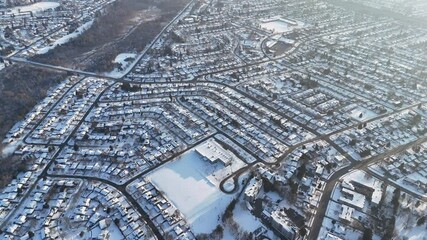 Wall Mural - Aerial drone view of Snow-covered roads, highways, and cloudy sky in Waterloo, Ontario, Canada