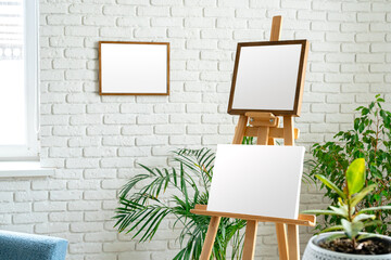 Poster - art studio setup with empty canvas and fresh greenery surrounded by minimalist decor