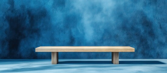 Poster - Elegant wooden desk platform on a soft blue textured backdrop perfect for showcasing modern designs or stylish products centered in the image