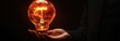 © ANUAR - Bright Idea in Hand: Person Holding Glowing Light Bulb Symbolizing Innovation, Creativity, Inspiration, and Bright Future in Dark Background