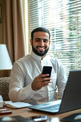 Poster - A man in business attire is sitting behind a desk, using a smartphone. He has a broad smile on his face, suggesting satisfaction or good news. The setting suggests a professional environment with a