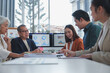 © crizzystudio - Asian business team analyzing financial charts displayed on computer screens, collaborating and discussing data in a modern office meeting, working together on a project