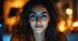 © ANUAR - Close-Up Portrait of a Young Woman with Glasses Smiling in a Cozy Room with Ambient Lights and Warm Bokeh Background Feeling Positive and Inspired