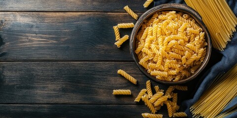 Aufkleber - Stylish arrangement of macaroni and spaghetti in a wooden bowl on a dark wooden surface with scattered pasta creating a culinary inspiration scene