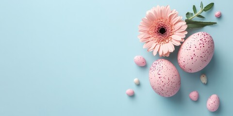 Poster - Delicate pink Easter eggs with speckles arranged beside a pink gerbera daisy and pastel candies on a soft blue background.