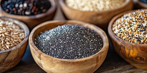 Aufkleber - Assorted organic seeds in wooden bowls featuring black chia seeds in the foreground with sesame and assorted grains in a soft brown background.