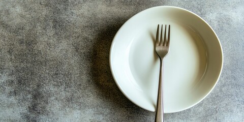 Poster - Minimalist top view of an empty white dish and fork on gray textured table surface, highlighting simplicity in culinary presentation and dining setup.