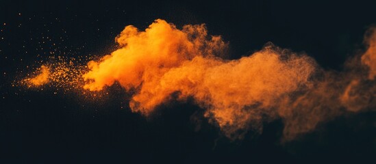 Aufkleber - Dynamic orange powder explosion creating a striking contrast against a dark background for artistic or advertising use.
