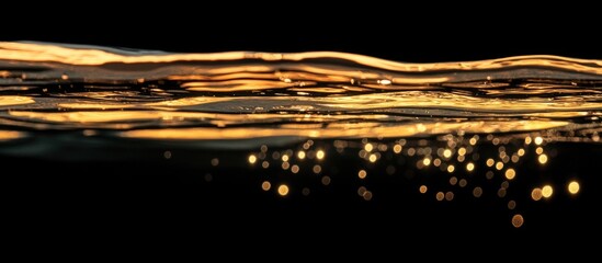 Leinwandbilder - Golden bubbles reflecting light on the surface of water creating a textured pattern against a dark background