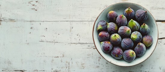 Aufkleber - Bowl of fresh ripe figs arranged on a textured white table in a flat lay style showcasing their natural colors and beauty.