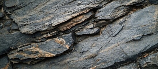 Poster - textured gray stone surface with irregular shapes and layers, showcasing a natural and rugged appear