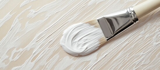 Aufkleber - White paintbrush on a light wooden surface creating a textured pattern for home improvement and renovation projects.