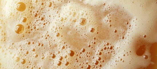 Poster - Beer froth texture in glass showcasing bubbles and creamy foam for beverage background or promotional material in top view perspective