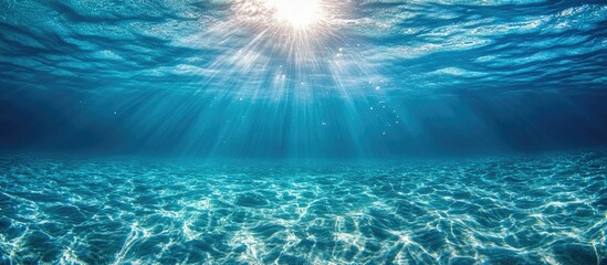 Aufkleber - Sunlight filtering through clear blue water creating mesmerizing bubble effects in an underwater scene.